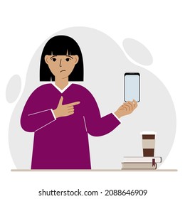 A sad woman holds a mobile phone in one hand and points at it with the index finger of his other hand. Vector flat illustration