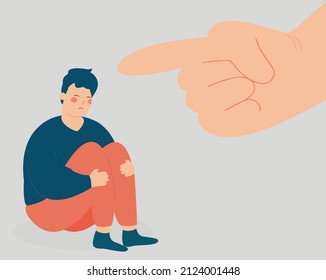 Sad young man suffers from violence and bullying from people. Stressed boy victime of abuse sits on the floor while a big finger is pointing at him. psychological violence, public censure concept.