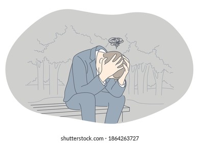 Sadness, mental depression, bad news concept. Young unhappy man sitting on bench with head in hands feeling depressed with thoughts after negative events, crying, suffering from loneliness 