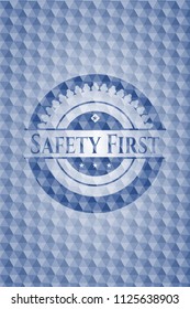 Safety First blue emblem with geometric pattern.