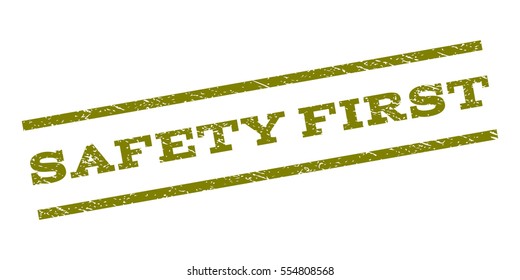 Safety First watermark stamp. Text caption between parallel lines with grunge design style. Rubber seal stamp with dirty texture. Vector olive color ink imprint on a white background.