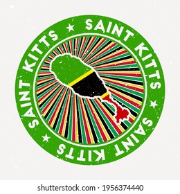 Saint Kitts round stamp. Logo of the island with a flag. Vintage badge with circular text and stars, vector illustration.