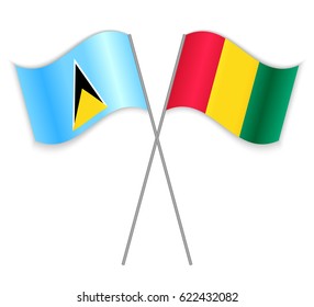Saint Lucian and Guinean crossed flags. Saint Lucia combined with Guinea isolated on white. Language learning, international business or travel concept.