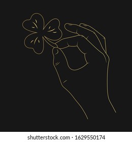 Saint Patrick day golden banner with hand holding a gold clover for holiday party in outline. 