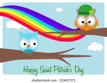 saint patrick's day card, two owls sitting on branches, one of them is a lucky leprechaun with a green hat and clover and a beautiful rainbow