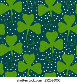 Saint Patrick's day green background. Seamless vector clover shamrock pattern. Hand drawn.