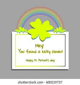 Saint Patrick's Day greeting card with a funny text and a cultural symbol of the celebration: green paper-cut silhouette of four-leaf shamrock, surrounded by three-leaf ones and with rainbow above.