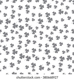Saint Patrick's Day vector seamless pattern with gray clover. Festive Endless template for wrapping, decoration, banner and advertisement backdrop. Graphic leafs on white background