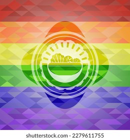 icono de ensalada dentro del emblema sobre fondo de mosaico con los colores de la bandera LGBT. 