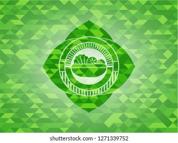 salad icon inside green emblem with mosaic ecological style background