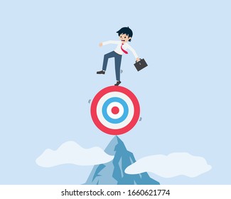 Salary Man Standing On A Target At The Summit Of A High Mountain At High Risk. If The Goal Is Not Appropriate There Will Be A High Risk