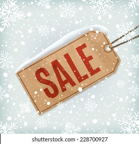 Sale paper tag on background with snowflakes and snow. Winter sale. Christmas sale. New year sale. Vector illustration