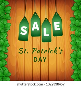 Sale poster of Saint Patrick's day with emerald shamrocks on wooden background and hanging green tags. Vector illustration