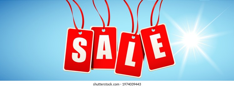 Sale - Red hanging tags with capital letters with sky and sunlight background