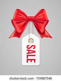 Sale tag with red gift bow. Vector sale paper label illustration for christmas discount promotion.