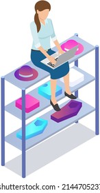 Sales manager in clothing store checking orders from customers in laptop using online shopping platform. Woman sitting with computer on shelves with garments, corresponding in online chat with client