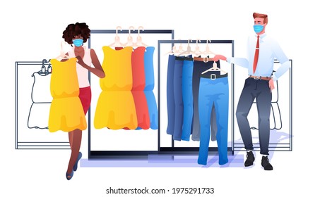salesman in mask showing clothes to female customer in fashion boutique coronavirus pandemic quarantine concept