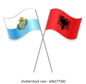 Sammarinese and Albanian crossed flags. San Marino combined with Albania isolated on white. Language learning, international business or travel concept.