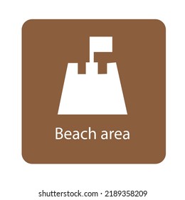 Sand castle with flag and the text beach area