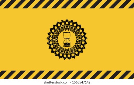 sand clock icon black grunge emblem inside yellow warning sign. Vector Illustration. Detailed.