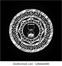sand clock icon drawn on a chalkboard