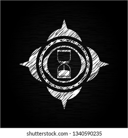 sand clock icon drawn on blackboard