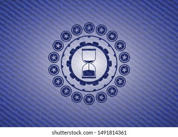 sand clock icon inside badge with jean texture