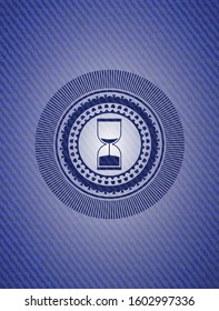 sand clock icon inside badge with jean texture