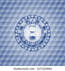 sand clock icon inside blue emblem with geometric pattern.