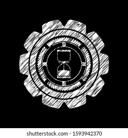 sand clock icon inside chalk emblem written on a blackboard
