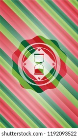 sand clock icon inside christmas emblem background.