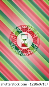 sand clock icon inside christmas emblem background.