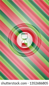 sand clock icon inside christmas colors style emblem.