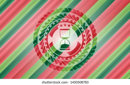 sand clock icon inside christmas colors badge.