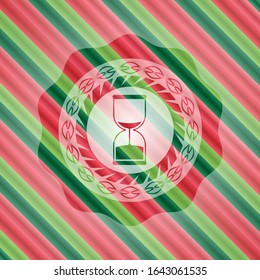 sand clock icon inside christmas badge.