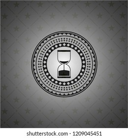 sand clock icon inside dark emblem