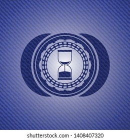 sand clock icon inside denim background
