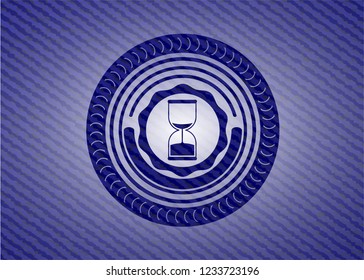 sand clock icon inside emblem with denim high quality background