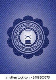 sand clock icon inside emblem with jean texture