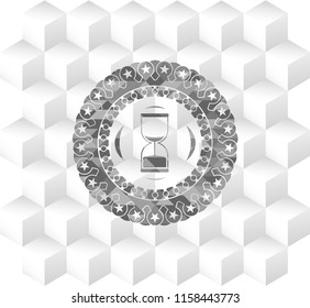 sand clock icon inside grey badge with geometric cube white background