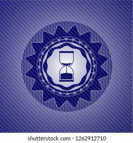 sand clock icon inside jean or denim emblem or badge background