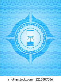 sand clock icon inside light blue water emblem background.
