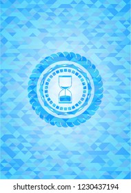 sand clock icon inside light blue emblem. Mosaic background