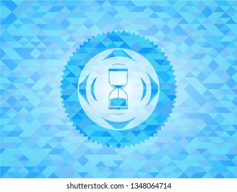 sand clock icon inside light blue mosaic emblem