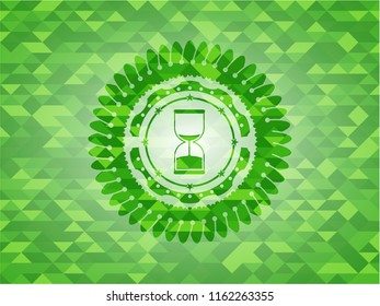 sand clock icon inside realistic green emblem. Mosaic background