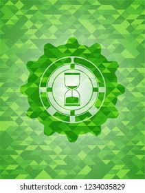 sand clock icon inside realistic green emblem. Mosaic background
