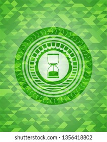 sand clock icon inside realistic green emblem. Mosaic background