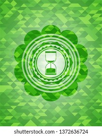 sand clock icon inside realistic green mosaic emblem