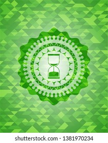 sand clock icon inside realistic green emblem. Mosaic background