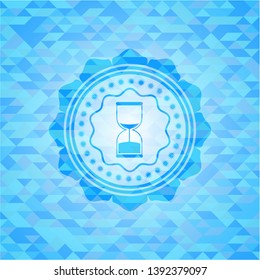 sand clock icon inside realistic light blue mosaic emblem